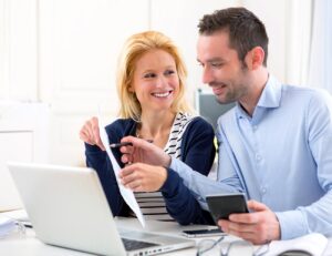 Jacksonville home selling couple looking at Red Door Realty Group website on laptop