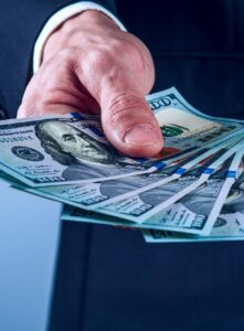 Businessman Man Handing $100 bills out