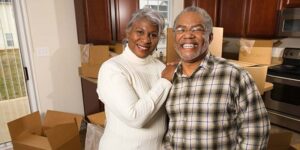 Senior 55+ African American couple packing to move from New York to Northeast, Florida