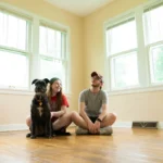 Home buyers and their dog in the empty living room of their next home discussing the Northeast Florida housing market